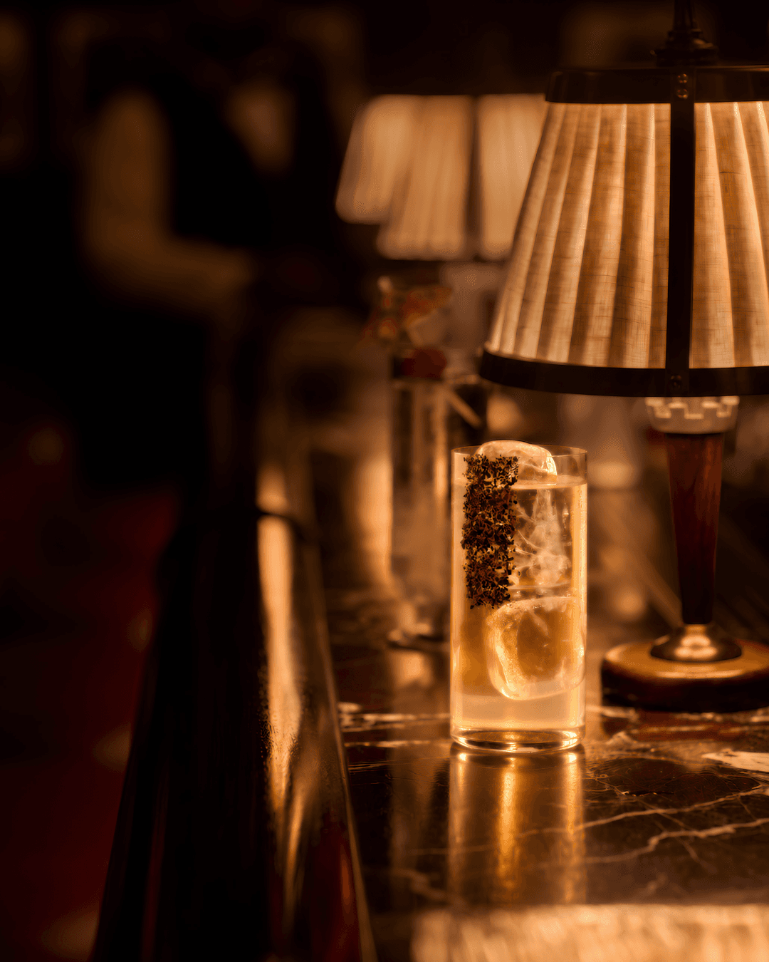 Dyane Paris cocktail presented in a highball glass at the bar