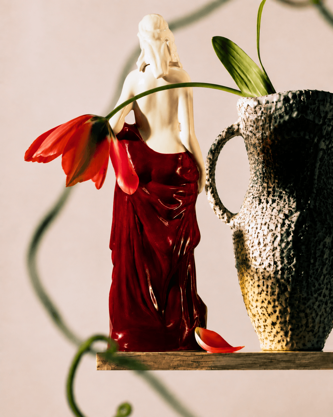 Porcelain sculpture with red drapery in a Dyane Paris floral composition