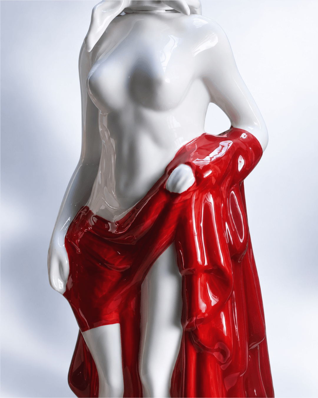 Detail of the red drapery of a Dyane Paris porcelain sculpture